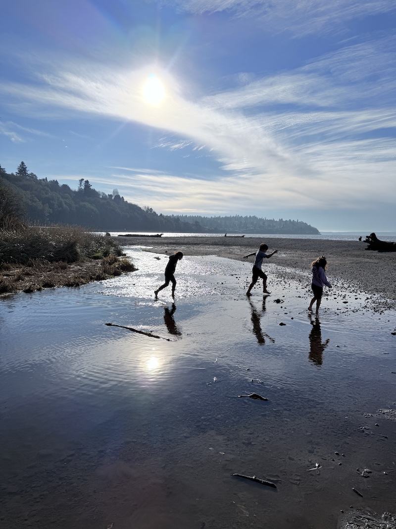 Kids at the beach showing how to homeschool without recreating school at home but exploring the world.
